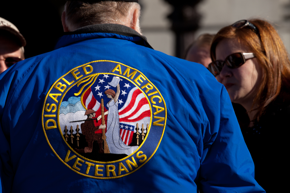An unidentified women talks to a disabled American veteran