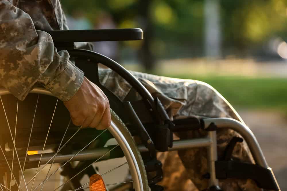 A veteran using a wheelchair outdoors, illustrating service-connected disabilities considered for TDIU benefits eligibility.