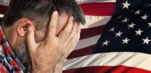 Veteran experiencing severe headache symptoms related to VA disability benefits for migraines.