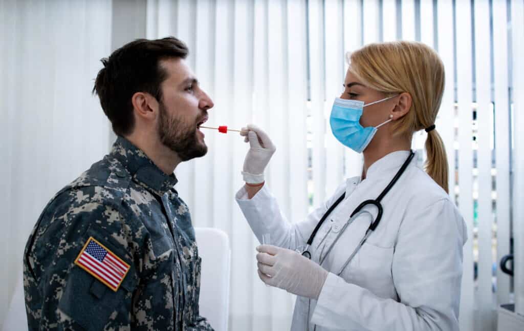Veteran receiving oral examination from healthcare professional to determine eligibility for VA dental care services