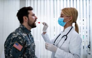 Veteran receiving oral examination from healthcare professional to determine eligibility for VA dental care services